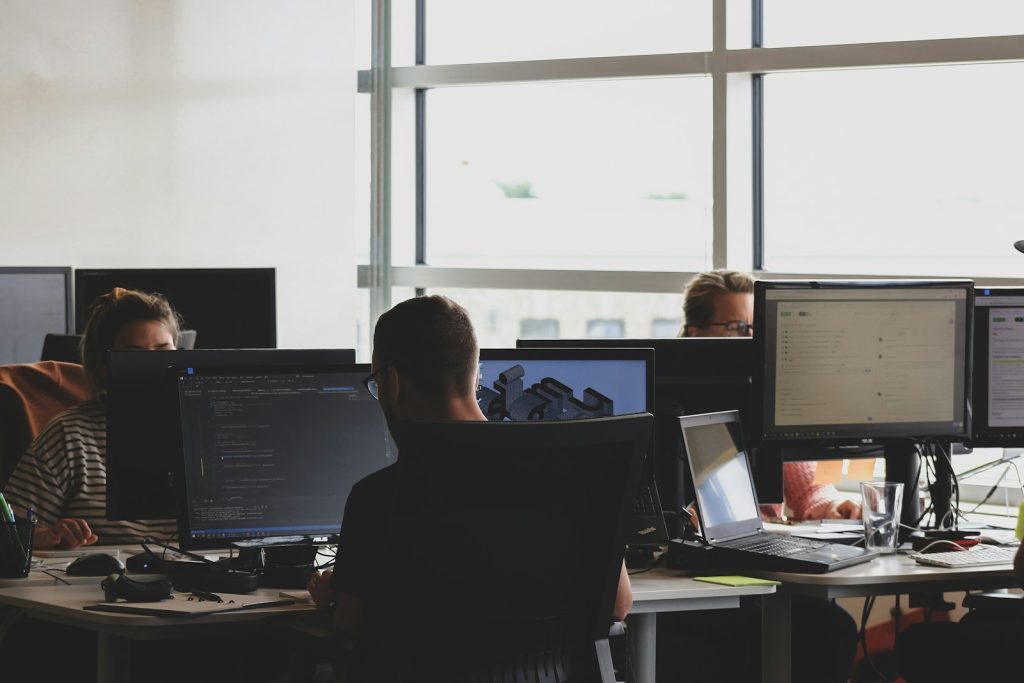 Photo by Sigmund people sitting on chair in front of computer monitor