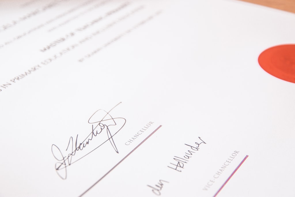 Photo by Jakub Żerdzicki a person is writing on a piece of paper